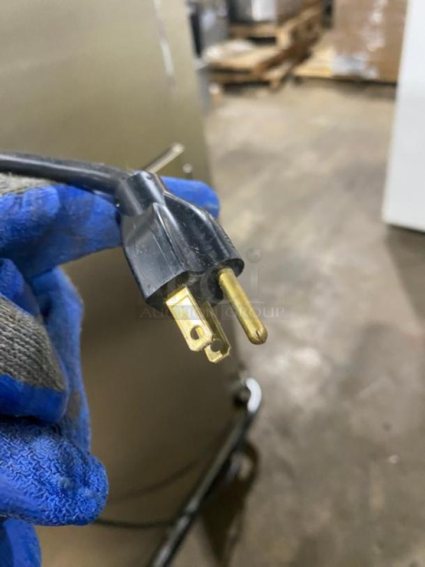 Close-up view of the power plug for an FWE Model MTU-12PDD heated holding cabinet, showing a three-prong electrical connector.