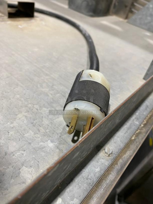 Plug and cord of Victory Commercial Stainless Steel Pass-Thru Heated Cabinet, Model HS1DPT, 230V, shown on a metal surface.