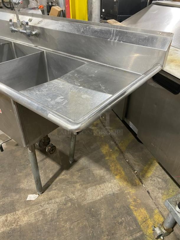 Duke Manufacturing stainless steel 3-compartment dishwashing sink with left/right drainboards, backsplash, and faucet.