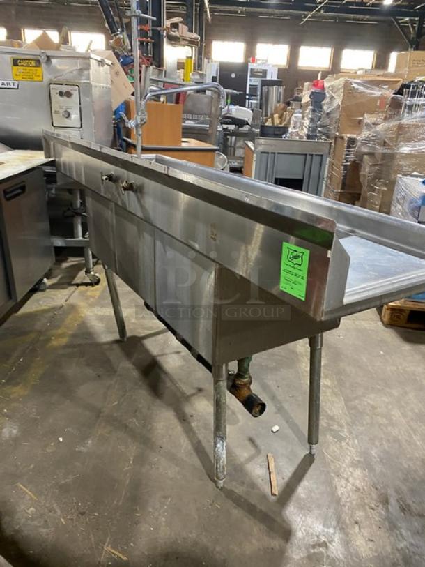 Duke Manufacturing stainless steel 3-compartment sink with left/right drain boards, backsplash, and swing spout faucet on legs.