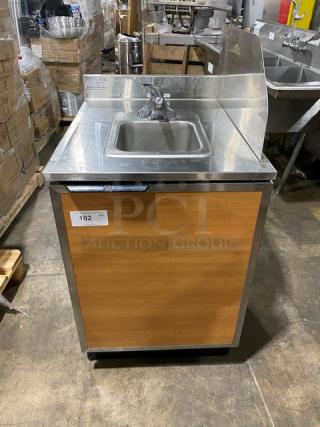 Duke Manufacturing stainless steel hand washing cabinet, model SUBPS24CM, with back and right-side splash, wooden front panel.
