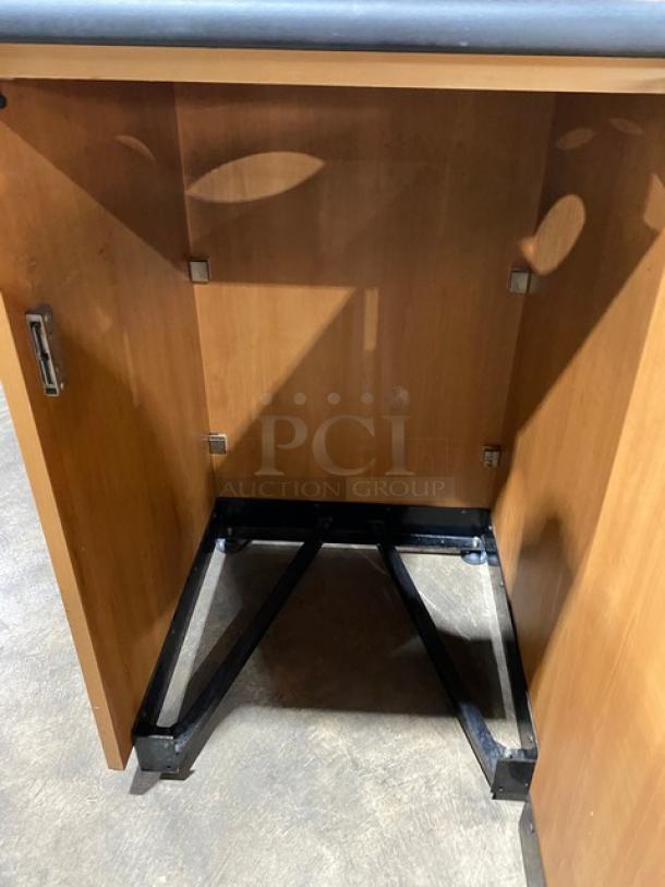 Commercial wooden trash cabinet, recycle-style, with upper serving tray storage, on legs, visible interior frame.