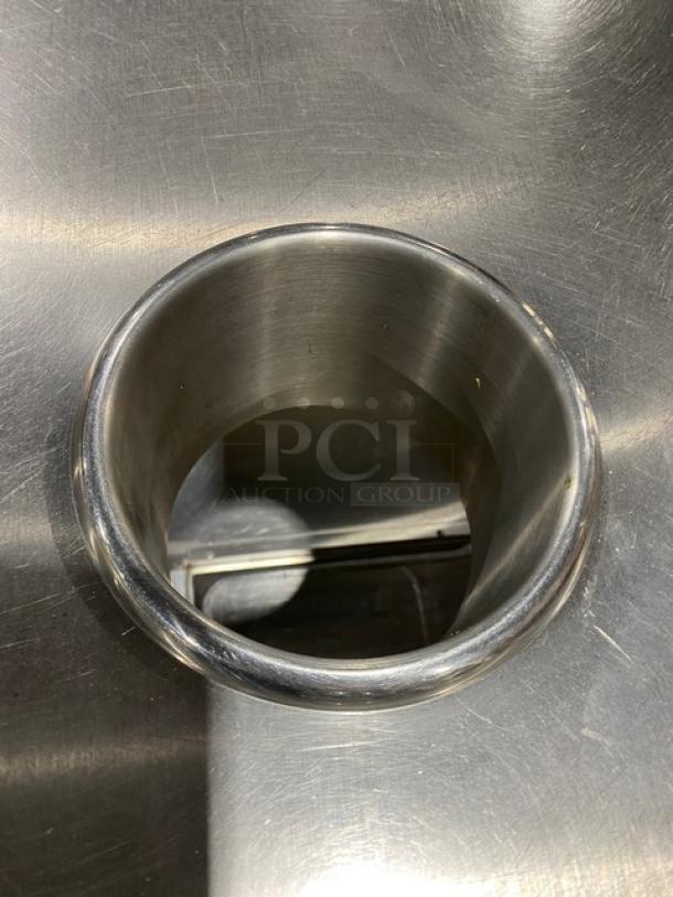 Duke Manufacturing stainless steel worktop prep table with round trash chute cut-out, model DC-7202-6030, on legs.