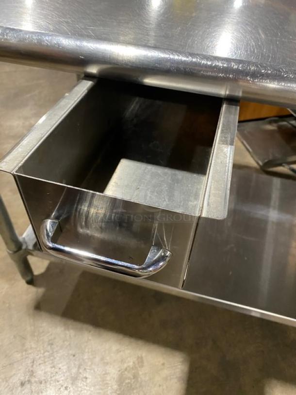 Duke Manufacturing stainless steel prep table, Model DC-7202-6030, with undershelf, round waste chute cut-out, on legs.