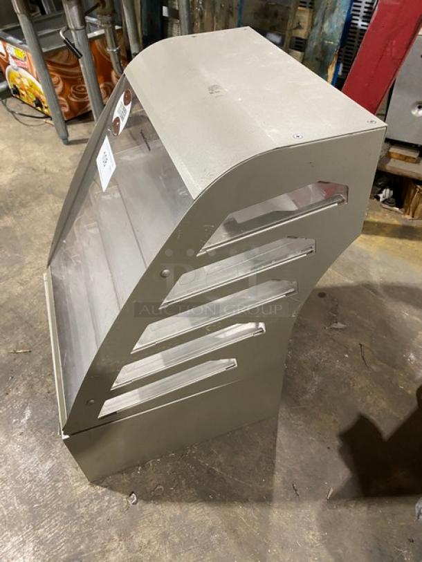 Subway style commercial dry multi-tier countertop dessert merchandiser with clear pull-out trays, good condition.