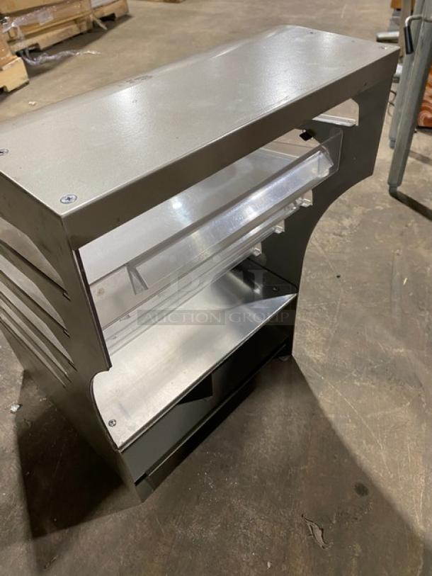 Subway style commercial dry multi-tier countertop dessert merchandiser with clear pull-out trays, in good condition.