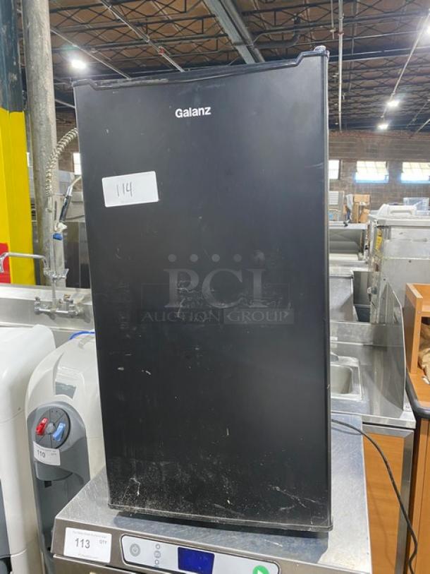 Galanz GLR33MBKE23 black single door mini refrigerator, commercial model, shows surface wear, 120V, SN: BX23110240115.