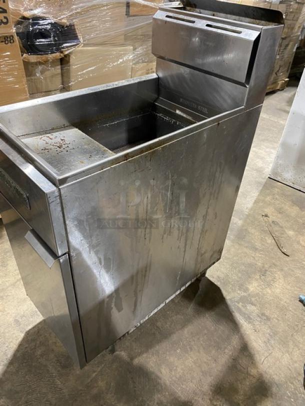 American Range commercial stainless steel natural gas deep fat fryer with backsplash and basket hanger, on legs, used condition.