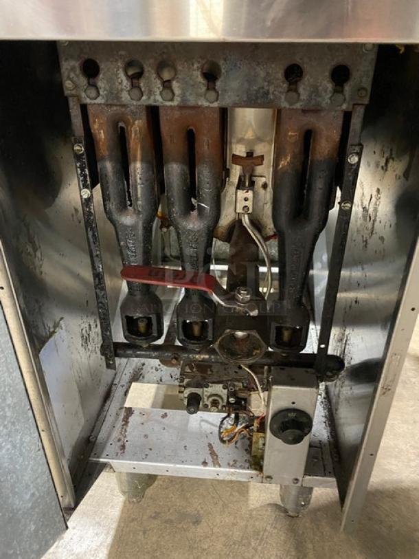 American Range commercial stainless steel natural gas deep fat fryer, featuring a backsplash, basket hanger, and mounted on legs.