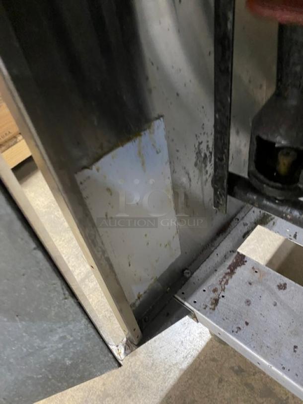 American Range commercial stainless steel deep fat fryer, natural gas-powered, with backsplash and basket hanger, shown on legs.