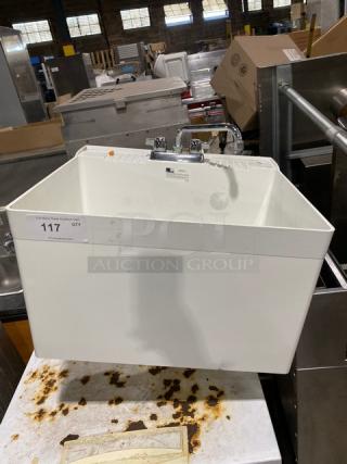 Commercial white single compartment mop service basin with swing spout faucet and legs, in good condition.