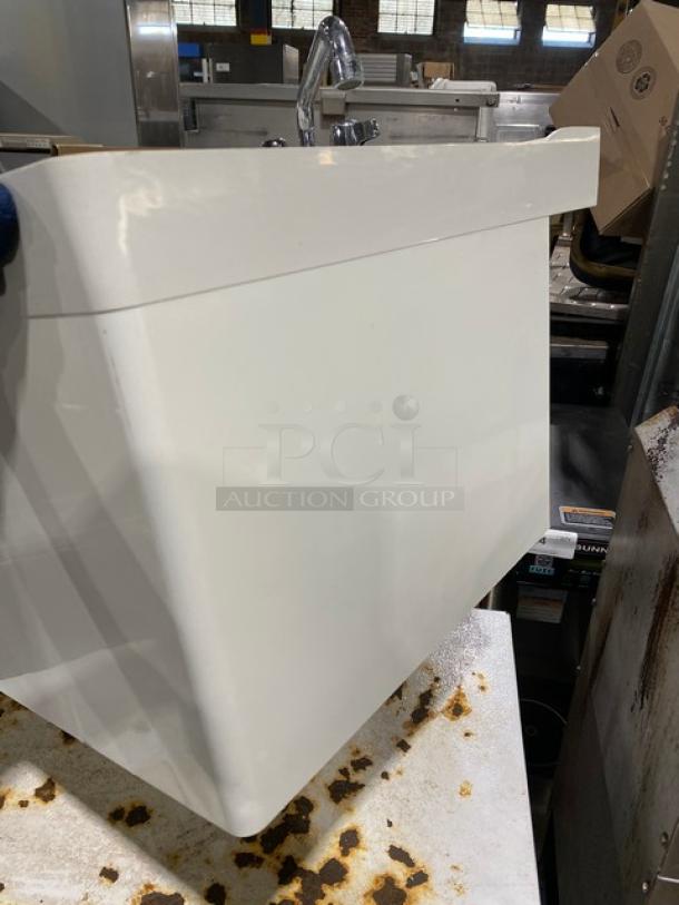Commercial white single compartment mop service basin with swing spout faucet and legs, in good condition.