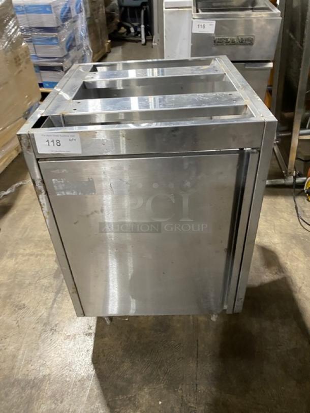Commercial stainless steel work cabinet with double pull-out shelves, enclosed design, on legs. Visible wear on surface.