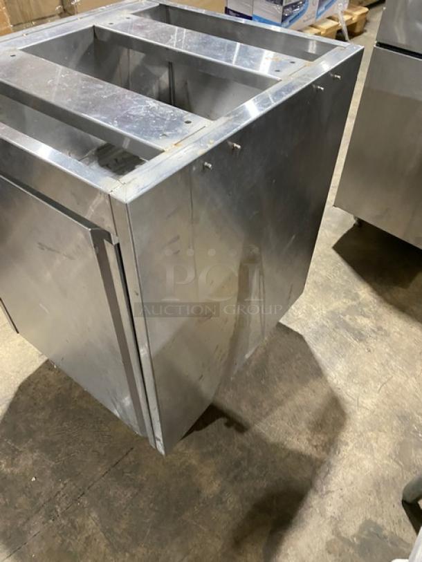 Custom stainless steel work cabinet with enclosed style, double interior pull-out shelves, on legs, in used condition.