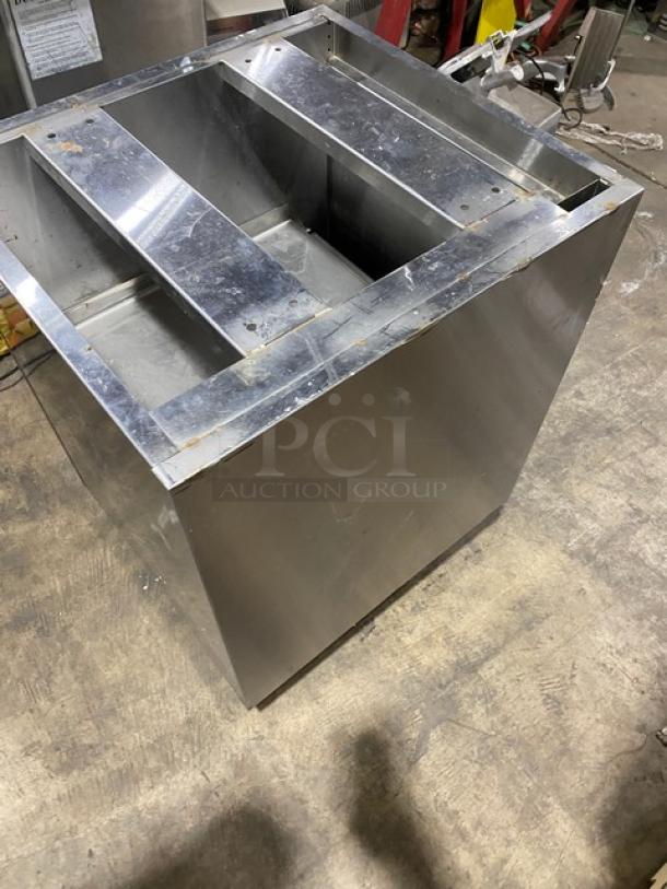 Custom commercial stainless steel work cabinet with double interior pull-out shelves, on legs. Minor surface wear visible.