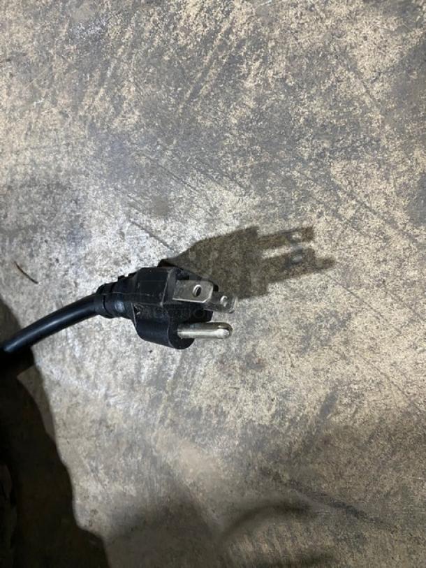 Power cord for Avantco Commercial Refrigerator, Model 178GDC15HCB. Three-prong plug shown against a concrete surface.