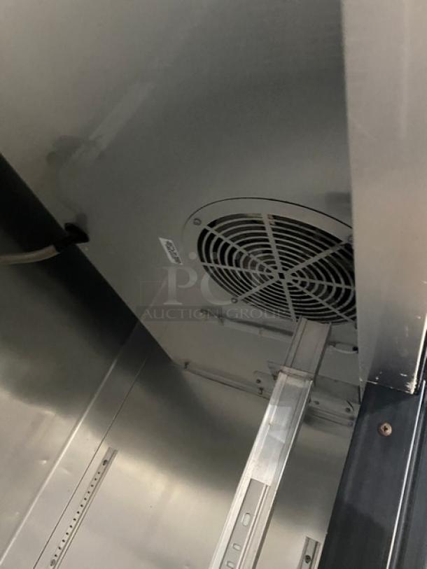 True T-35 Commercial Stainless Steel 2 Door Refrigerator interior with wire rack, fan, and caster wheels; Model SN: 8784235.