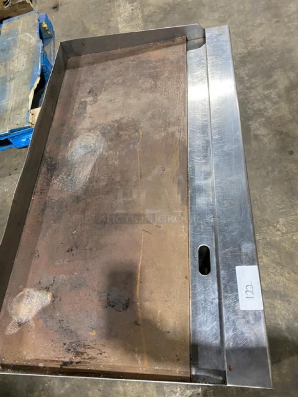 Cook Rite Commercial Stainless Steel Natural Gas Griddle, with back and side splash, on legs, showing wear.