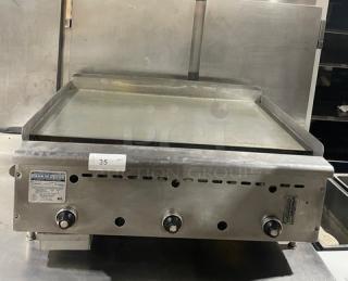 Rankin-Delux GT36C stainless steel 36" flat griddle, natural gas, thermostatic control, with back & side splash, on legs.
