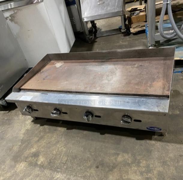 Cook Rite 48" stainless steel flat griddle, natural gas, with back and side splash. Features knobs and sturdy legs.