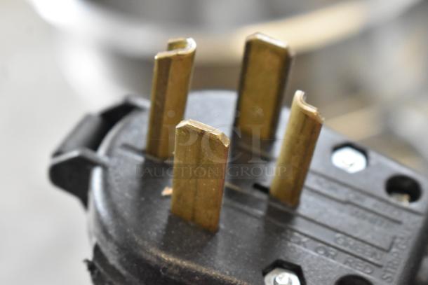 Close-up of plug for Precision HD-60 dough mixer, showing four prongs and part of a black casing with visible text.