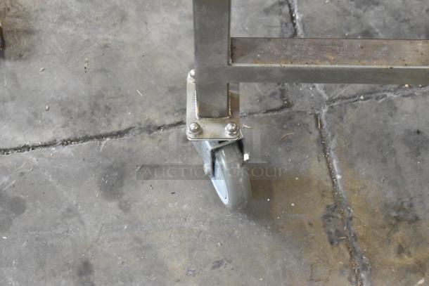 Stainless steel equipment stand with caster wheel for Turbochef HhC1618 oven, shown on a concrete floor.