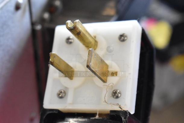 Close-up of a power plug for a Turbochef HhC1618 conveyor oven, showing its prongs and screws.