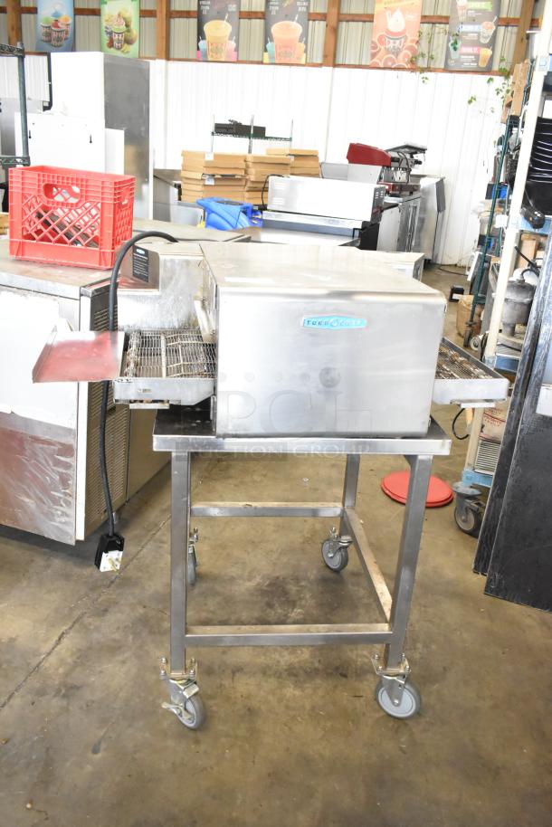 2022 Turbochef HhC1618 stainless steel rapid speed conveyor oven on stand with casters, 208/240V, 1 phase.