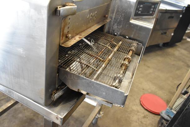 2022 Turbochef HhC1618 stainless steel rapid speed conveyor oven with digital controls on stand. Visible wear on conveyor.