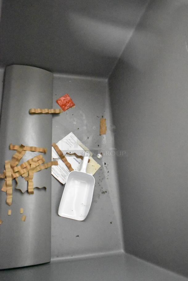 Stainless steel commercial ice bin, brand new, with minor scratches and dents, includes scoop.