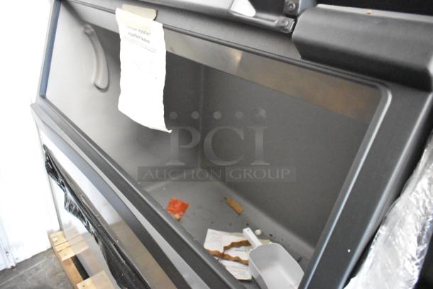 Stainless steel commercial ice bin, brand new with minor scratches. Includes installation notice and scoop.