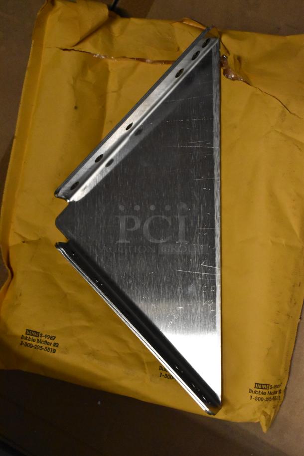 Metal bracket on a yellow bubble mailer. Brushed finish, slight scratches visible; suitable for shelving or support.