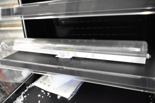 Brand new Avantco 193MAC26HCB 28" black vertical air curtain merchandiser on commercial casters, 115V, 1 Phase.