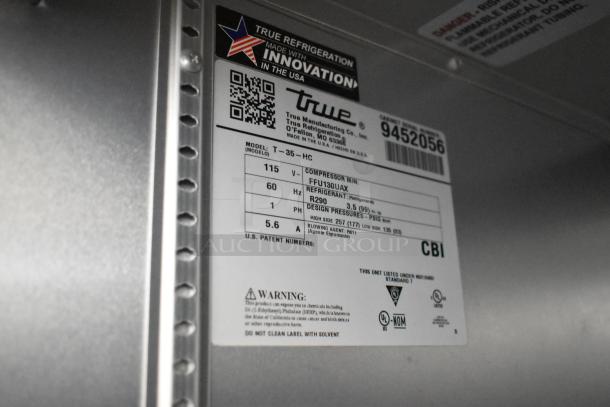 Label on a True T-35-HC commercial cooler, states model, voltage, refrigerant info, and safety warnings.