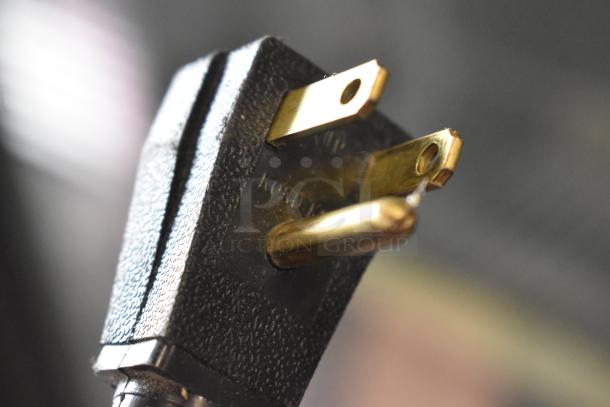 Close-up of a power plug for the 2018 True T-35-HC commercial cooler, 115V, 1 phase. Black textured grip with visible prongs.