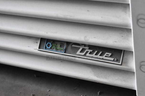 2021 True TSCI-600R-G-PH cooler with "natural refrigerant" label, metal exterior, poly-coated racks, 115 volts, single phase.