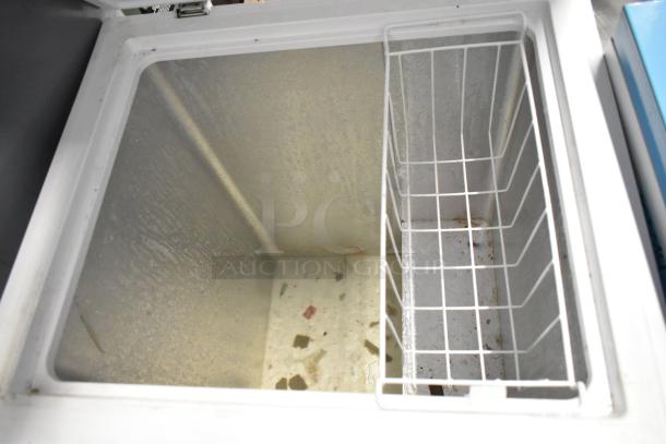Hisense WFC050M6XWD metal chest freezer with hinge lid, 115V, 1 Phase. Interior basket included, showing signs of wear.
