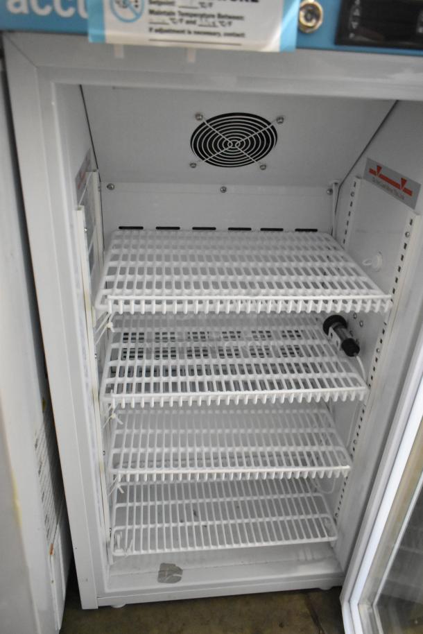 2 metal mini cooler merchandisers, models Accucold ARG3PV and Arctic King ARV115B1AST, 115V, 1 phase; interior shelves shown.