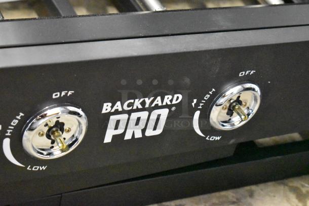 Brand new Backyard Pro 36" steel propane griddle, 60,000 BTU, foldable, mobile. Visible control knobs. Scratch and dent condition.