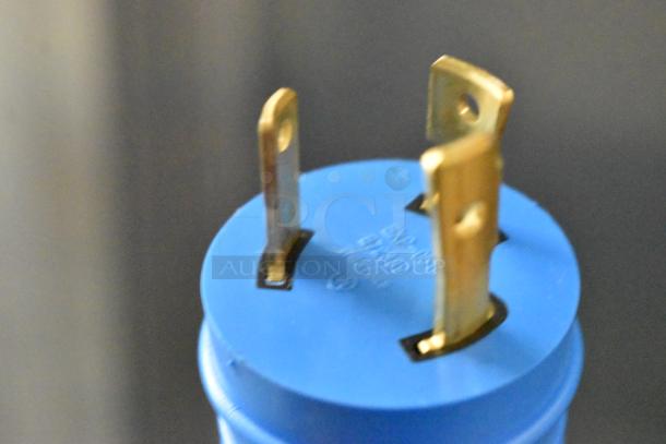 Close-up of a blue electrical plug with three prongs, part of the Advance Tabco HF-4E-240 steam table.
