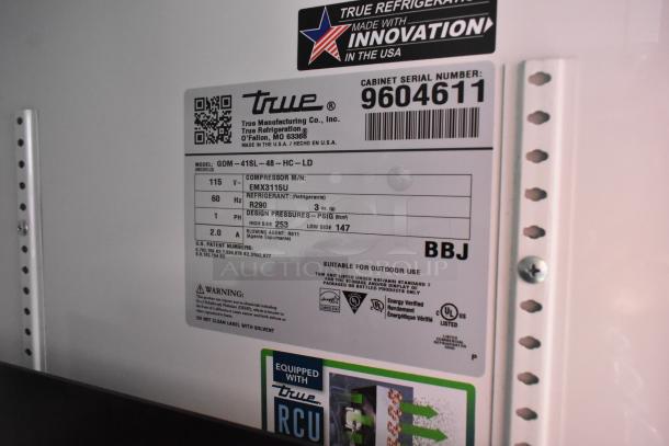 Label on 2019 True GDM-41SL-48-HC-LD commercial cooler indicating model, voltage, refrigerant type, and suitability for outdoor use.