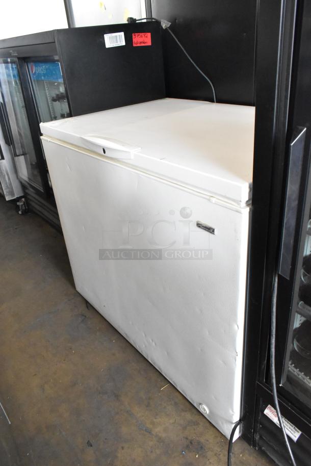 Kenmore 253.16342105 metal chest freezer with hinge lid, in used condition. 115 volts, 1 phase. Visible dents and wear.