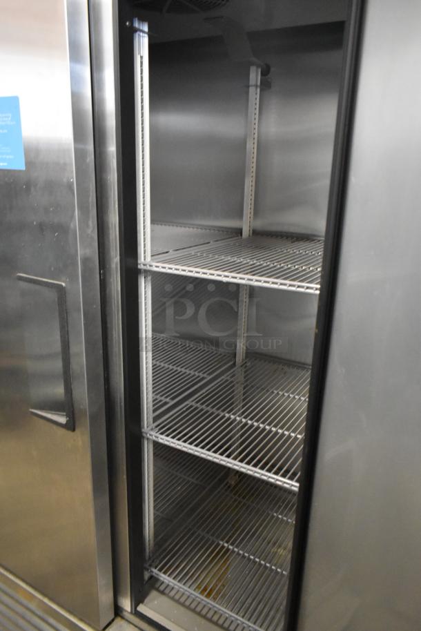 2021 True T-35-HC stainless steel commercial 2-door reach-in cooler with poly-coated racks, in excellent condition.