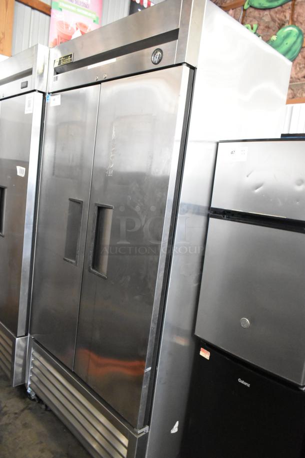 True T-35 stainless steel commercial 2-door reach-in cooler with poly-coated racks on casters. 115 Volts, 1 Phase.