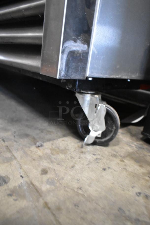 True T-35 stainless steel commercial cooler with poly-coated racks and casters. Shows detail of caster wheel.