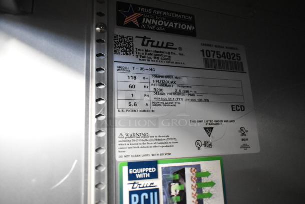 Label on a True T-35 cooler displaying model, serial number, voltage, and refrigerant details.