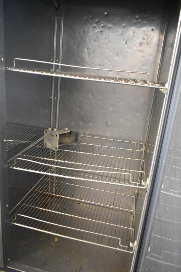 Turbo Air TSF-49SD stainless steel freezer interior with poly coated racks, 115V, 1 phase, showing moderate wear.