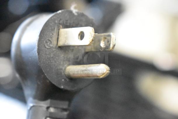 Close-up of a standard electrical plug attached to the 2017 True T-19F freezer.