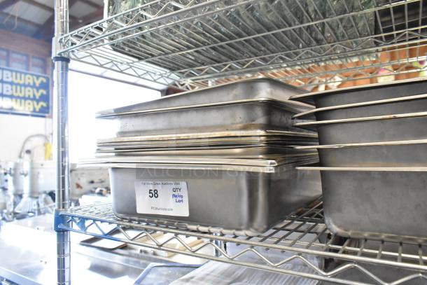 Metro lot of stainless steel bins and chafer lids on metal shelving, labeled "58 QTY Metro Lot." Shelving not included.