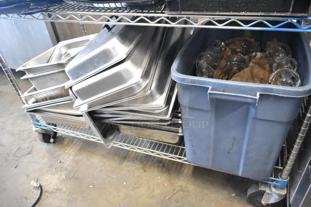 Metro lot with stainless steel drop-in bins, chafer lids, salad plates, and bowls on a cart. Excludes shelving unit.